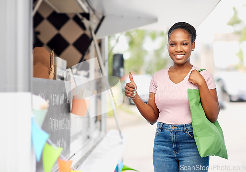 Image of woman with reusable bag over food truck