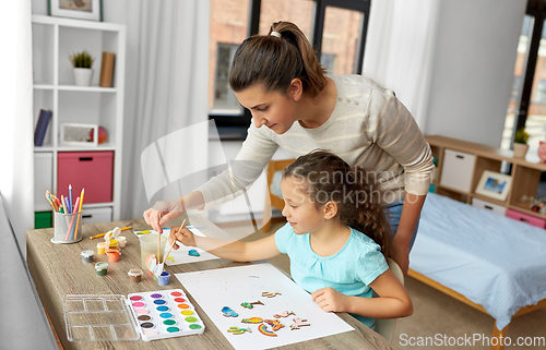 Image of mother with little daughter drawing at home