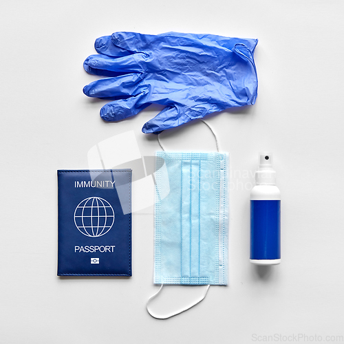Image of immunity passport, mask, gloves and hand sanitizer