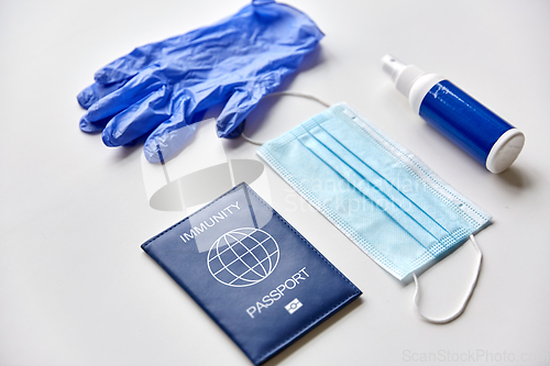 Image of immunity passport, mask, gloves and hand sanitizer