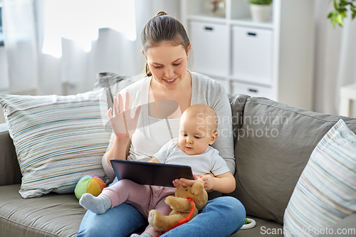 Image of mother with baby having video call on tablet pc