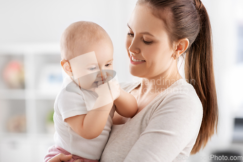 Image of happy mother with little baby daughter at home