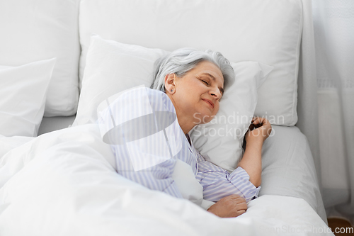 Image of senior woman sleeping in bed at home bedroom