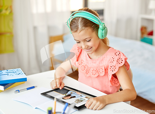 Image of girl with tablet pc having online class at home