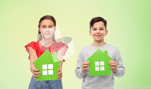 Image of smiling little girl and boy holding green houses