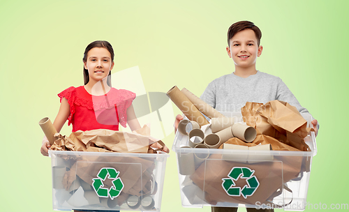 Image of smiling girl and boy sorting paper waste