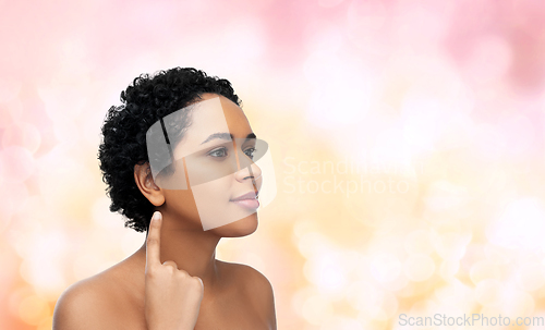 Image of african american woman showing her ear
