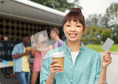 Image of happy asian woman drinking coffee over food truck