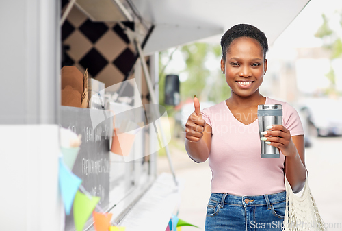 Image of woman with tumbler and food in string bag