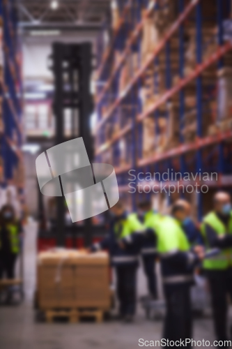 Image of Blur warehouse background. Warehouse worker taking package in the shelf in a large warehouse in a large warehouse