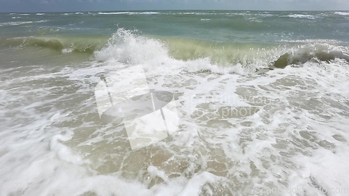 Image of Powerful ocean waves crashing on a coast. Extreme stormy ocean waves splashing on a Beach