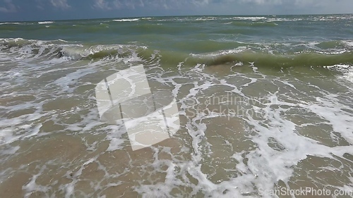 Image of Powerful ocean waves crashing on a coast. Extreme stormy ocean waves splashing on a Beach