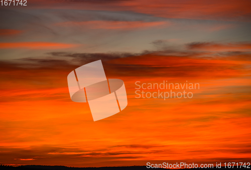 Image of colorful red and orange clouds in the sky right after sunset