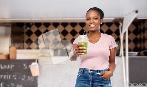 Image of african american woman with juice over food truck