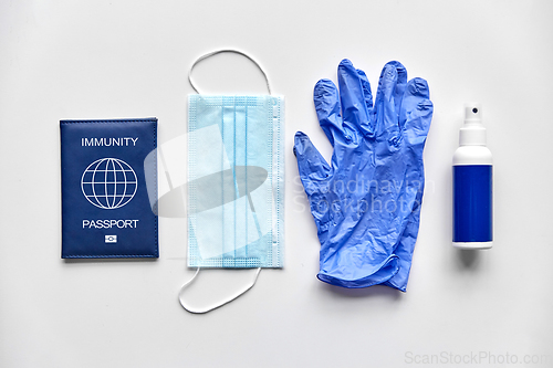 Image of immunity passport, mask, gloves and hand sanitizer