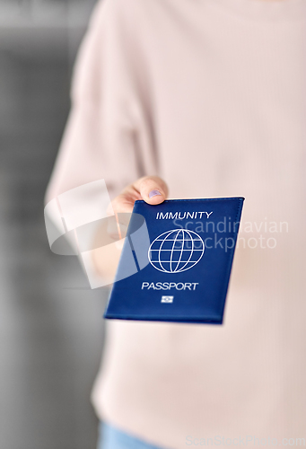 Image of close up of woman holding immunity passport