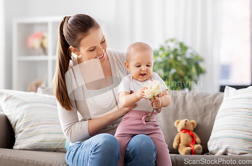 Image of happy smiling mother with little baby at home