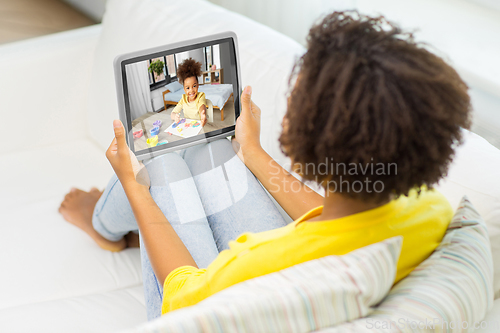 Image of mother has video call with daughter on tablet pc