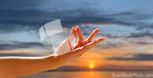 Image of hand of meditating yogi woman showing gyan mudra