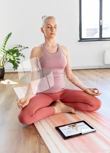 Image of woman with tablet pc having online yoga class