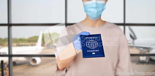 Image of close up of woman holding immunity passport