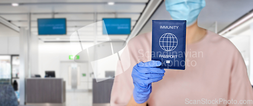 Image of close up of woman holding immunity passport
