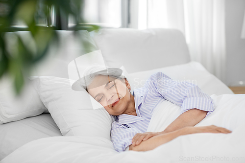 Image of senior woman sleeping in bed at home bedroom