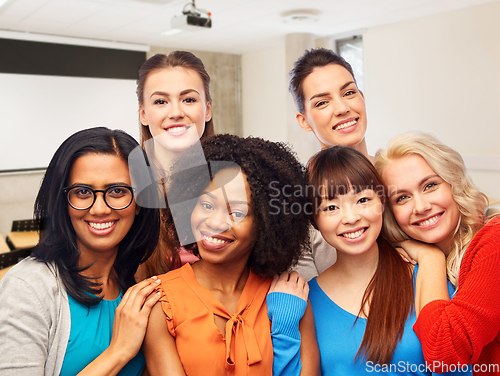 Image of group of happy student women hugging at university