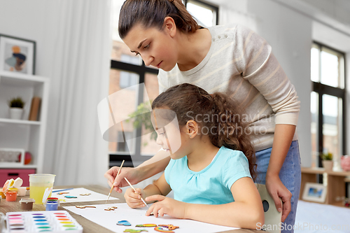 Image of mother with little daughter drawing at home