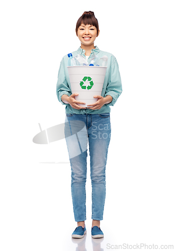 Image of smiling young woman sorting plastic waste