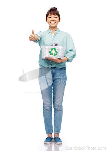 Image of smiling young asian woman sorting metallic waste