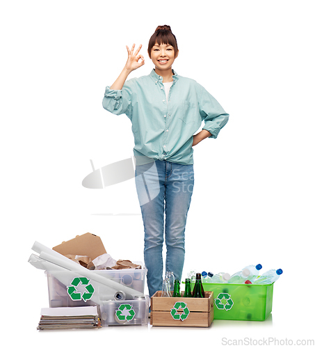 Image of happy woman sorting paper, metal and plastic waste