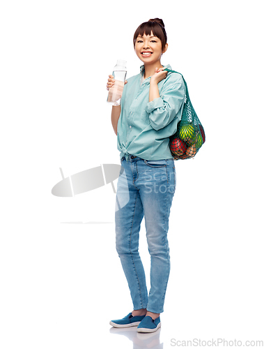 Image of woman with food in string bag and glass bottle