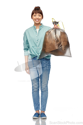 Image of asian woman holding plastic trash bag with waste