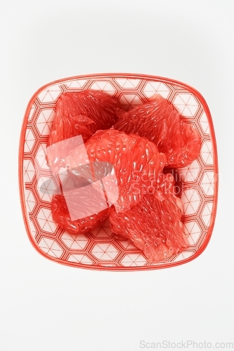 Image of juicy red grapefruit slices on a small plate