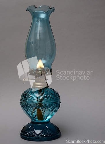 Image of burning vintage oil lamp on neutral