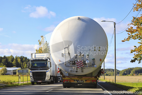 Image of Wide Load Transport of LNG Storage Tank On Road, Truck Takes Cau