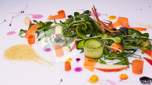 Image of Mix fresh leaves of arugula, lettuce, spinach, beets for salad on a white background. Selective focus