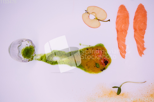 Image of Puree from apples and greens with salmon cubes. Conceptual aperitif.