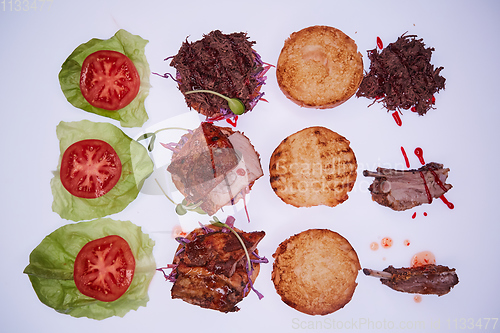 Image of Three open burgers with different fillings with a torn pork, with ribs and pork ribs on a white table