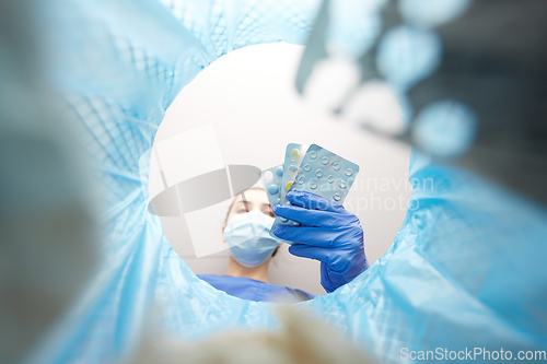 Image of doctor throwing medicine pills into trash can