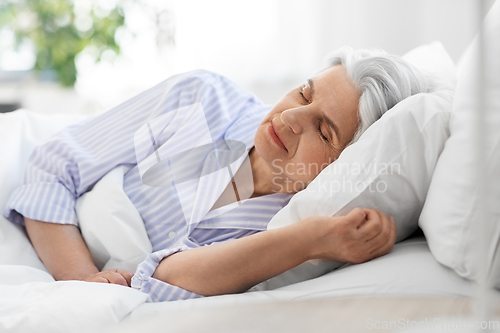 Image of senior woman sleeping in bed at home bedroom