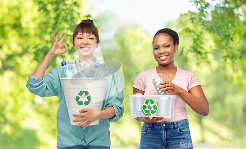 Image of happy women sorting plastic and metallic waste