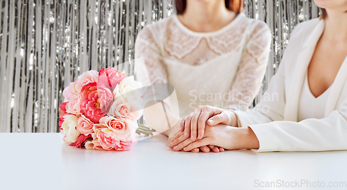 Image of close up of happy lesbian couple with flowers