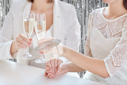 Image of close up of lesbian couple with champagne glasses