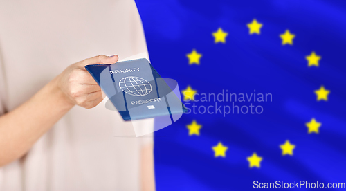 Image of close up of woman holding immunity passport