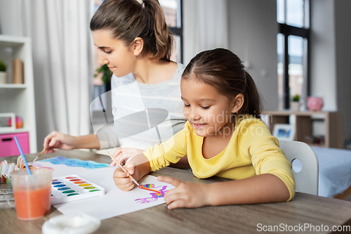 Image of mother with little daughter drawing at home