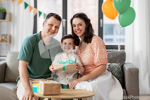 Image of parents giving birthday present to little son