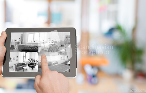 Image of hands with video control on tablet pc at home