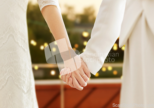 Image of close up of married lesbian couple holding hands